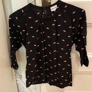 Black top with pink lightning strike pattern (European designer)